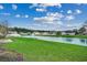 Expansive backyard with lush green lawn and a serene lake view, perfect for relaxation and outdoor activities at 645 Twinflower St., Little River, SC 29566