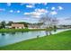 Scenic view of a tranquil lake with lush green lawn, offering a serene and picturesque setting at 645 Twinflower St., Little River, SC 29566