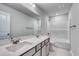 Bright bathroom featuring a double sink vanity, large mirror, and tub with white tiling surround at 667 Mccorkle Place, Conway, SC 29526