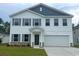 Charming two-story home with gray shutters, siding, and a two-car garage at 667 Mccorkle Place, Conway, SC 29526