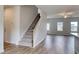 Inviting foyer with wood flooring, a stairway, and a view into the spacious living area at 667 Mccorkle Place, Conway, SC 29526