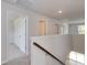 Second floor hallway with multiple doorways, wooden banister and overhead lighting at 667 Mccorkle Place, Conway, SC 29526