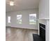 Bright living room featuring a fireplace, hardwood floors, and natural light from large windows at 667 Mccorkle Place, Conway, SC 29526