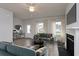 Staged living room boasting hardwood floors, comfortable furniture, and a cozy fireplace at 667 Mccorkle Place, Conway, SC 29526