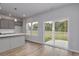 Bright living room featuring hard wood floors, gray cabinets, and sliding glass doors at 667 Mccorkle Place, Conway, SC 29526