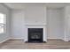 Living room showcasing a fireplace, hardwood floors, and a large window for ample natural light at 667 Mccorkle Place, Conway, SC 29526