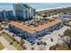 Aerial view of St. John's Inn, highlighting the pool, parking, and proximity to other beachside buildings at 6803 Ocean Blvd. N # 109, Myrtle Beach, SC 29572