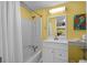 Bathroom with a shower-tub combo, white vanity, and decorative fish art at 6803 Ocean Blvd. N # 109, Myrtle Beach, SC 29572