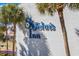 A view of the St. John's Inn brand logo on the side of the brick building at 6803 Ocean Blvd. N # 109, Myrtle Beach, SC 29572