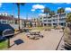 Outdoor grilling and picnic area with tables and charcoal grills, set amongst landscaping at 6803 Ocean Blvd. N # 109, Myrtle Beach, SC 29572