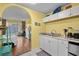 Bright kitchenette with white cabinets, granite counters, and view to the bedroom at 6803 Ocean Blvd. N # 109, Myrtle Beach, SC 29572