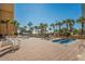 Inviting pool deck with hot tubs, sun loungers, and palm trees offering a serene oceanfront setting at 6803 Ocean Blvd. N # 109, Myrtle Beach, SC 29572
