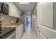 Functional kitchen featuring modern appliances, white cabinetry, and seamless access to living spaces at 6900 N Ocean Blvd. # 1235, Myrtle Beach, SC 29572