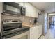 Galley kitchen featuring stainless steel appliances and white cabinets at 6900 N Ocean Blvd. # 1235, Myrtle Beach, SC 29572