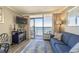 Comfortable living area showcasing ocean views from the balcony, along with a sofa and dining table at 6900 N Ocean Blvd. # 1235, Myrtle Beach, SC 29572