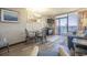 Relaxing living room area featuring a dining table and chairs, a sofa, and access to a private balcony at 6900 N Ocean Blvd. # 1235, Myrtle Beach, SC 29572