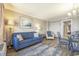 Living room featuring a comfortable blue sofa, dining table, and decor, leading to the bedroom and kitchen at 6900 N Ocean Blvd. # 1235, Myrtle Beach, SC 29572