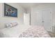 Bright bedroom with a floral comforter and pillow, a double closet, and an ensuite bathroom at 799 Mount Gilead Place Dr., Murrells Inlet, SC 29576