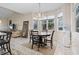 Well-lit dining area featuring a chandelier, large windows, and a round dining table at 799 Mount Gilead Place Dr., Murrells Inlet, SC 29576