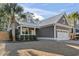 Inviting single-story home with a metal roof, covered front porch, and two car garage at 799 Mount Gilead Place Dr., Murrells Inlet, SC 29576