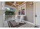 Relaxing front porch featuring rocking chairs, ceiling fan, and decorative railing at 799 Mount Gilead Place Dr., Murrells Inlet, SC 29576