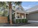 A charming view of the home's front porch, accented by lovely landscaping and a beautiful palm tree at 799 Mount Gilead Place Dr., Murrells Inlet, SC 29576