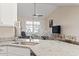 Bright kitchen with granite countertops, stainless sink, and open view to the living room at 799 Mount Gilead Place Dr., Murrells Inlet, SC 29576