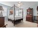 Comfortable main bedroom with a four-poster bed, soft blue walls, and ample closet space at 799 Mount Gilead Place Dr., Murrells Inlet, SC 29576