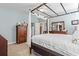 Inviting main bedroom with a four-poster bed, neutral carpet, and a dresser at 799 Mount Gilead Place Dr., Murrells Inlet, SC 29576