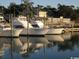 Picturesque marina scene showcasing yachts docked along the waterfront, reflecting golden light on the calm waters at 799 Mount Gilead Place Dr., Murrells Inlet, SC 29576