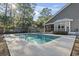 Outdoor swimming pool in the backyard with a patio and covered lounge area at 799 Mount Gilead Place Dr., Murrells Inlet, SC 29576