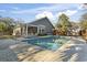 Backyard swimming pool bordered by a concrete patio, home, shed, and privacy fence at 799 Mount Gilead Place Dr., Murrells Inlet, SC 29576