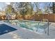 In-ground pool featuring a fenced-in yard, a storage shed, and surrounding shade trees at 799 Mount Gilead Place Dr., Murrells Inlet, SC 29576
