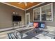 Cozy screened-in porch with an abundance of comfortable seating and a wood plank ceiling at 799 Mount Gilead Place Dr., Murrells Inlet, SC 29576