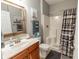 Well-lit bathroom with a shower and tub combo, a wood-framed mirror and gray walls at 828 Sail Ln. # 203, Murrells Inlet, SC 29576