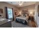 Cozy bedroom featuring a comfortable bed with decorative pillows, soft lighting, and a ceiling fan at 828 Sail Ln. # 203, Murrells Inlet, SC 29576