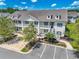 Charming two-story condo with white balconies and a well-maintained landscaped yard at 828 Sail Ln. # 203, Murrells Inlet, SC 29576