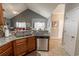 Open kitchen with stainless steel dishwasher, granite counters, and easy access to the living and dining areas at 828 Sail Ln. # 203, Murrells Inlet, SC 29576