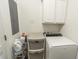 Functional laundry room with washer, storage drawers, and overhead cabinets for organizing supplies at 828 Sail Ln. # 203, Murrells Inlet, SC 29576