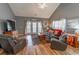 Comfortable living room featuring vaulted ceilings, hardwood floors, and access to outdoor balcony at 828 Sail Ln. # 203, Murrells Inlet, SC 29576