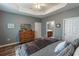 Calming main bedroom with tray ceiling, natural light, and a view into ensuite bathroom at 828 Sail Ln. # 203, Murrells Inlet, SC 29576