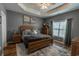 Relaxing main bedroom featuring tray ceilings, neutral paint, and wood furnishings at 828 Sail Ln. # 203, Murrells Inlet, SC 29576