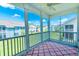 Enclosed screened-in porch with patterned rug and a view of the exterior and neighborhood at 828 Sail Ln. # 203, Murrells Inlet, SC 29576