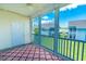 Enclosed screened-in porch with patterned rug and a view of the exterior and neighborhood at 828 Sail Ln. # 203, Murrells Inlet, SC 29576