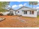 A view of the rear of the property showing a metal roof, fenced in yard with pine straw at 9514 Leeds Circle, Myrtle Beach, SC 29588