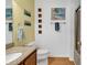 Charming bathroom with a well-lit vanity, sink, toilet, shower and wooden floors at 9514 Leeds Circle, Myrtle Beach, SC 29588