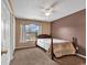 The bedroom features neutral colored walls, carpeted floors, a ceiling fan, and a bright window at 9514 Leeds Circle, Myrtle Beach, SC 29588