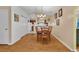 The dining room has a modern chandelier, hardwood flooring, and offers a view to the kitchen at 9514 Leeds Circle, Myrtle Beach, SC 29588