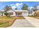 Charming one-story home featuring a metal roof, front porch and concrete driveway at 9514 Leeds Circle, Myrtle Beach, SC 29588