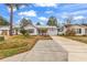 Street view of a single story home boasting tidy landscaping, an American flag, and a metal roof at 9514 Leeds Circle, Myrtle Beach, SC 29588